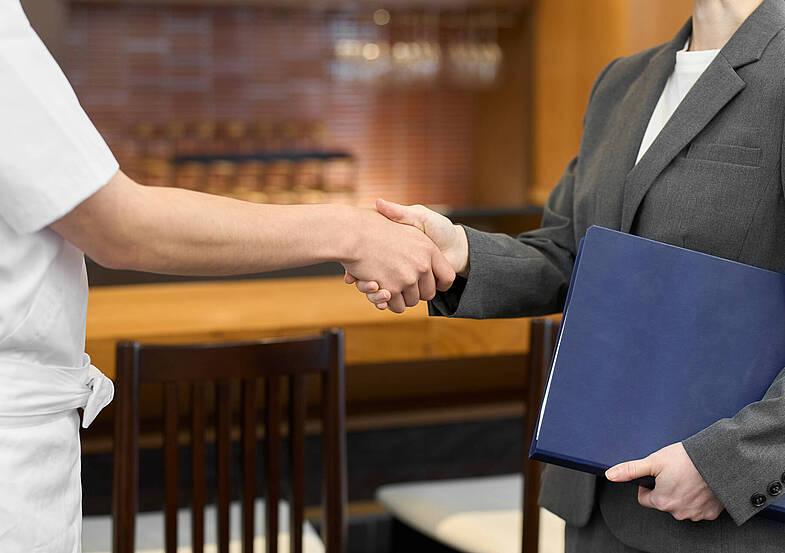 Businesswomen shaking hands at a restaurant