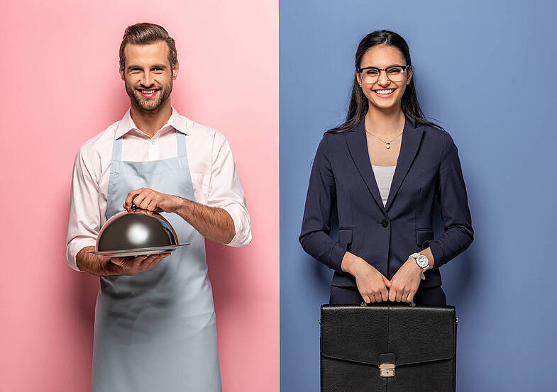 happy man in apron with Serving Tray and businesswoman with briefcase on blue and pink