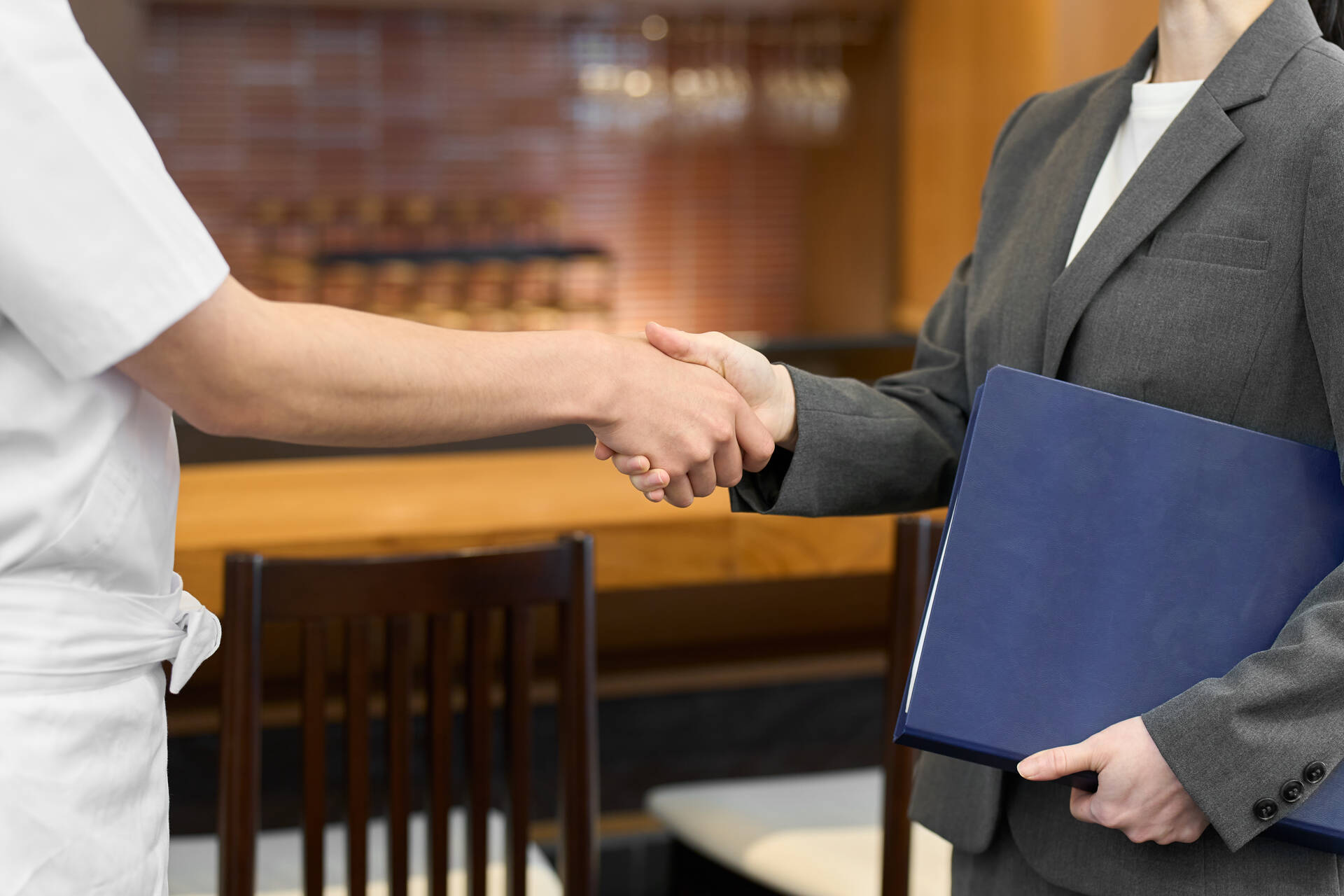 Businesswomen shaking hands at a restaurant